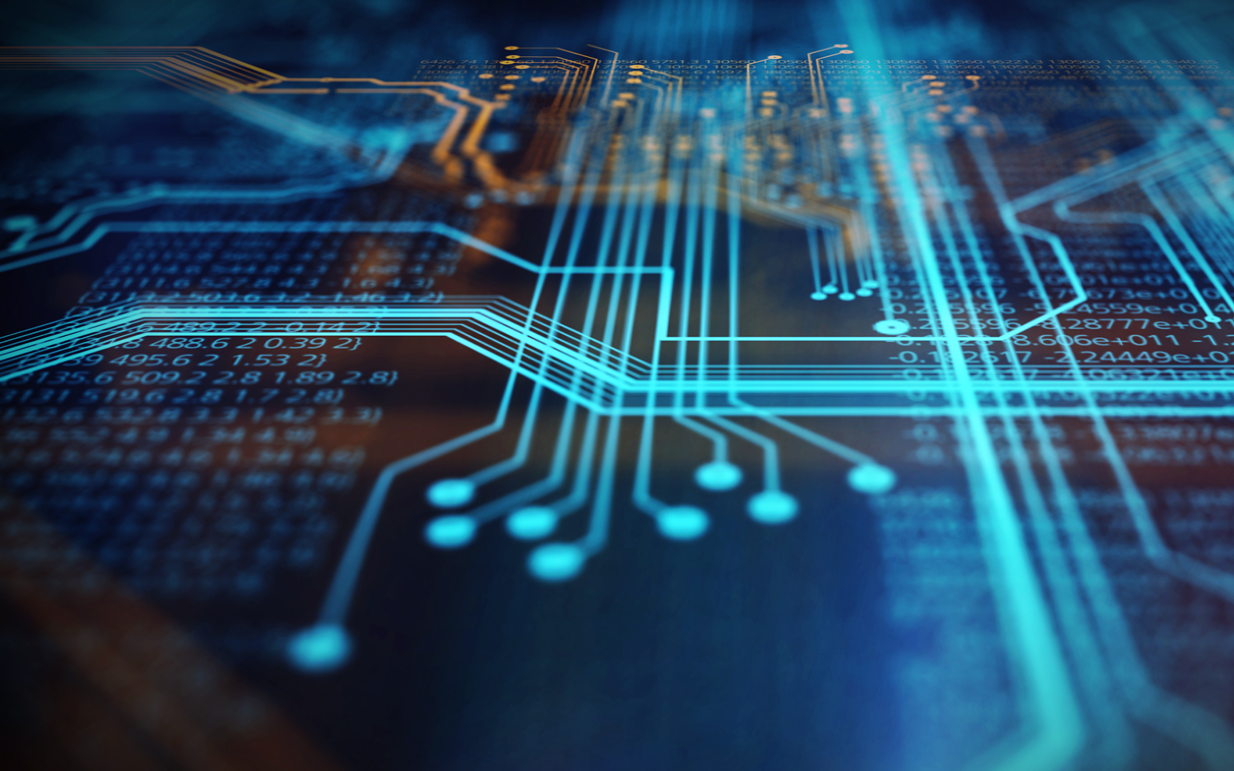 Close-up of a circuit board with glowing blue and orange pathways.